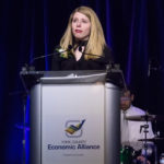 Woman is speaking at a podium during the 2018 YCEA dinner