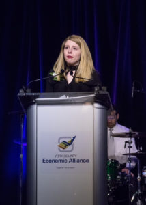 Woman is speaking at a podium during the 2018 YCEA dinner