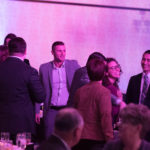 A crowd of YCEA staff talking during the 2018 dinner