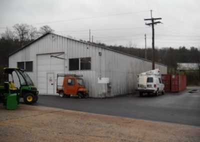 Industrial building with vehicles parked outside
